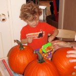 Evan carving pumpkins